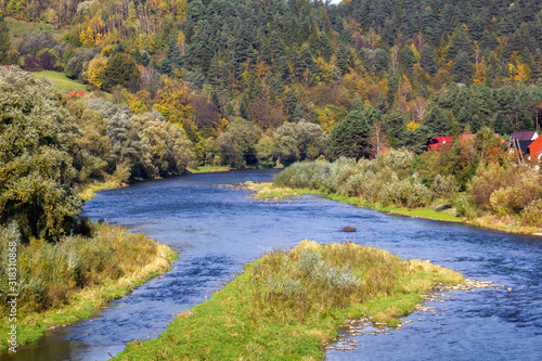 Poprad River in Autumn. View from bridge over Poprad between Piwniczna-Zdroj  Poland and Mnisek nad Popradom  Slovakia.