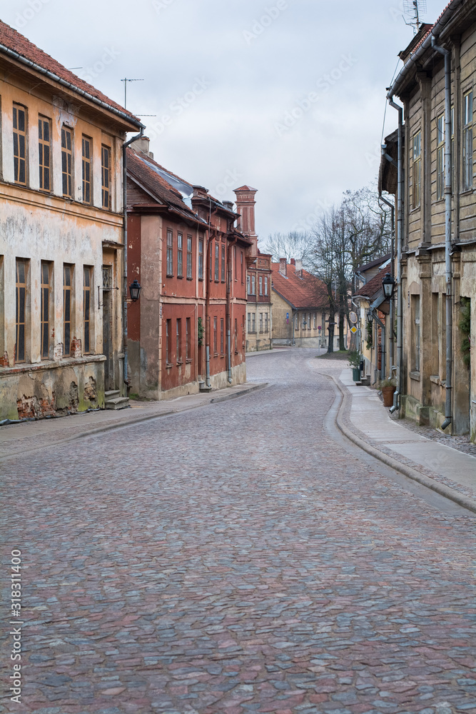 Old city street with old stone and wooden facades and stone paving road Old city street with old stone and wooden facades and stone paving road