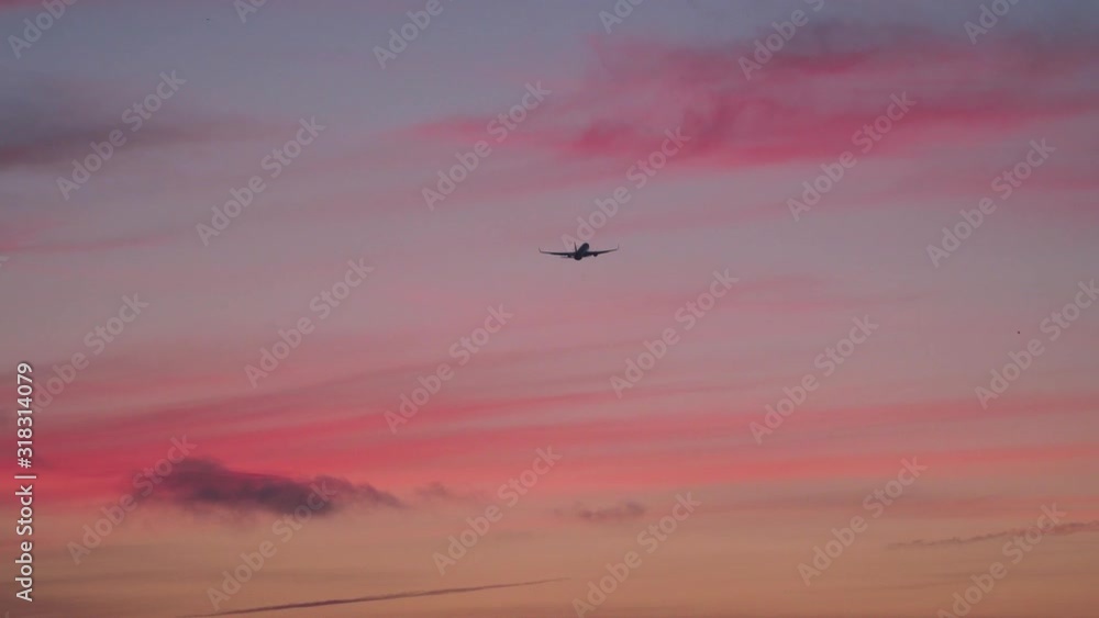 Aircraft is flying in sunset sky. Travel, business trip, air transport, commercial transportation concept Aircraft is flying in sunset sky. Travel, business trip, air transport, commercial transportation concept