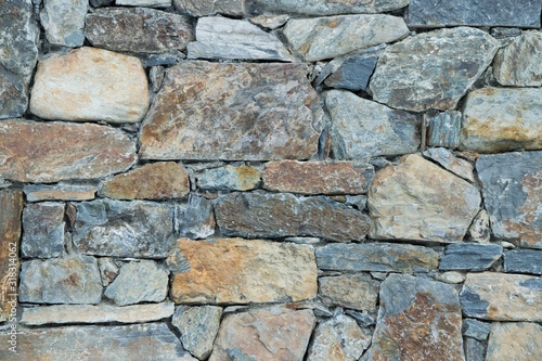 Stone wall with dominant grey color, background concept