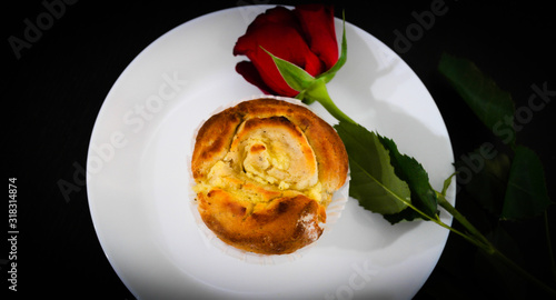 Tasty bun and red rose