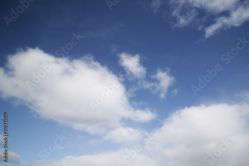 background of white fluffy cumulus clouds