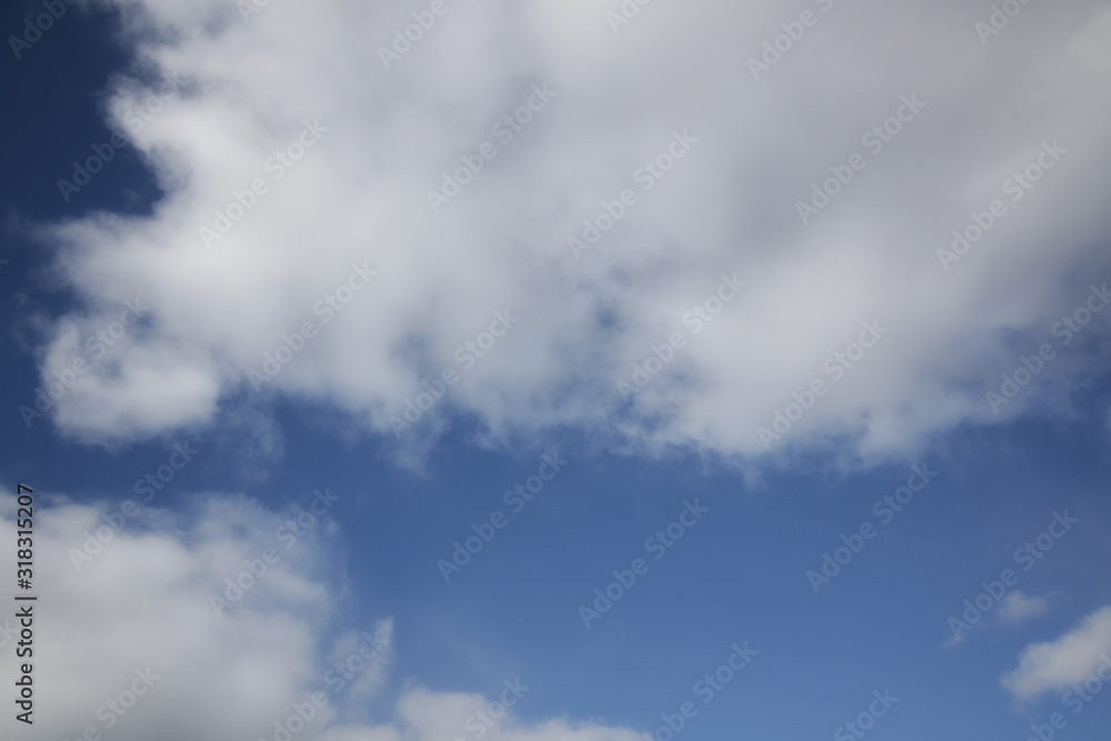 background of white fluffy cumulus clouds