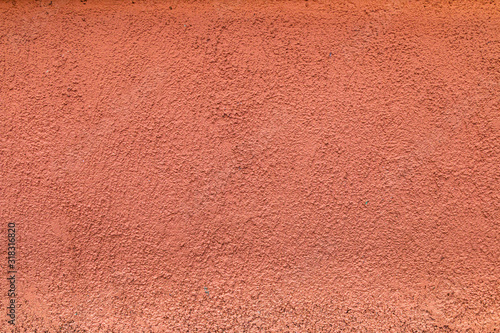 orange concrete wall with many irregularities