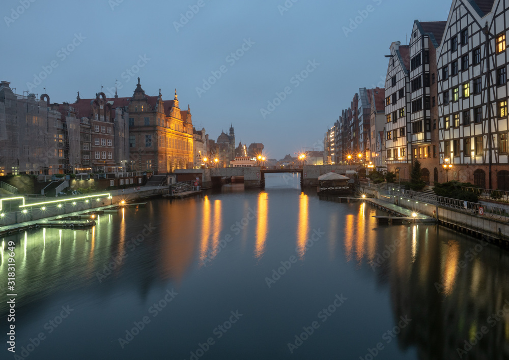 Night view of the old part of the city. Gdansk, Poland. Green bridge, ancient beautiful building and Motlawa river