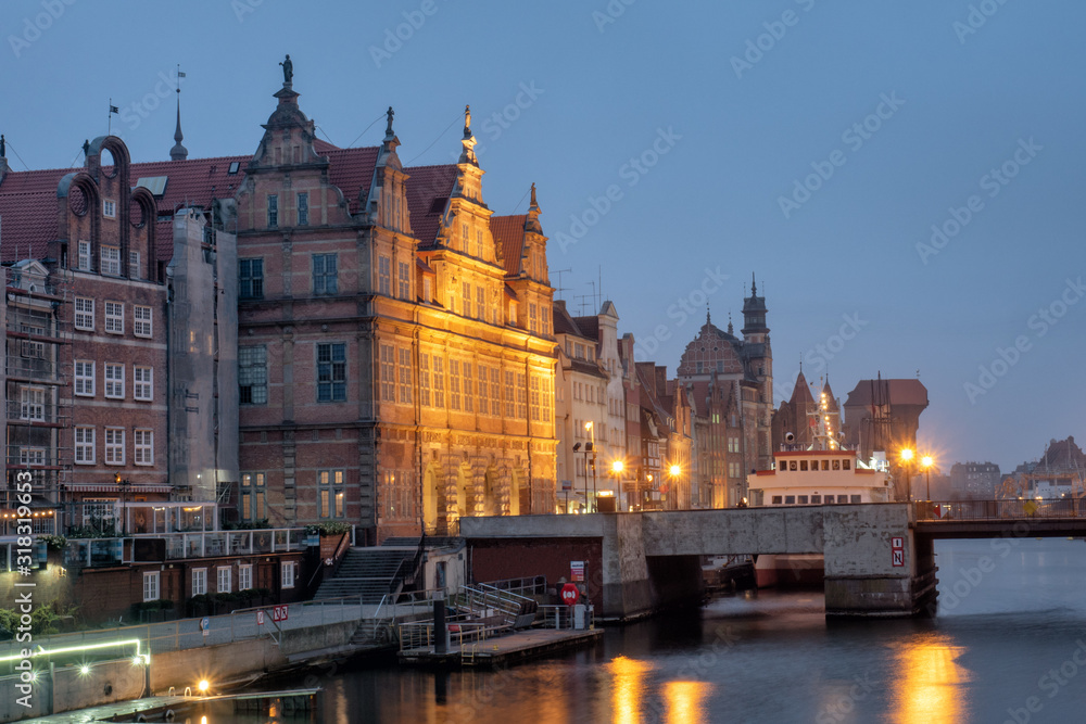Night view of the old part of the city. Gdansk, Poland. Green bridge, ancient beautiful building and Motlawa river