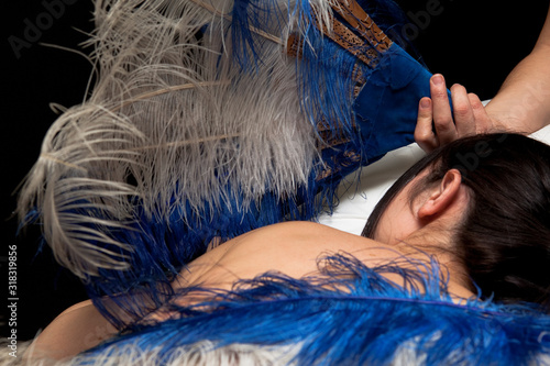 Relaxing massage with feathers in spa
