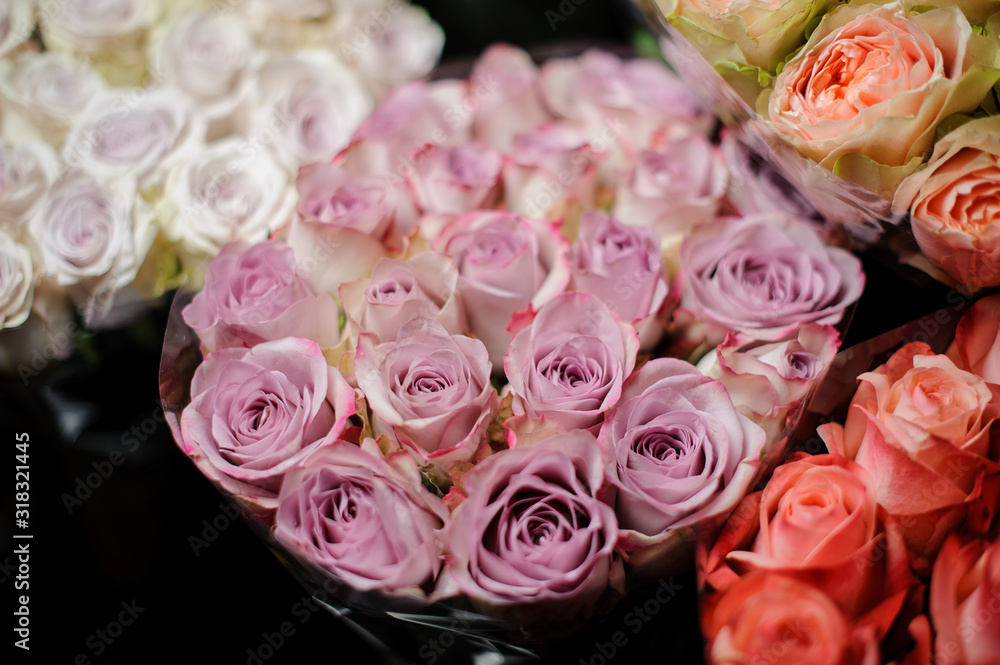Beautiful bouquet of violet color roses in the transparent wrapping paper Beautiful bouquet of violet color roses in the transparent wrapping paper