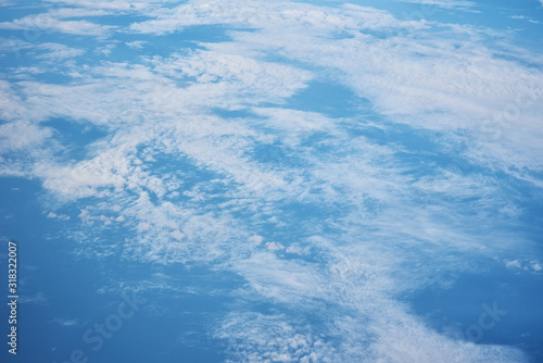 Blue cloudy sky, view from the airplane window. Aerial view of cloudscape