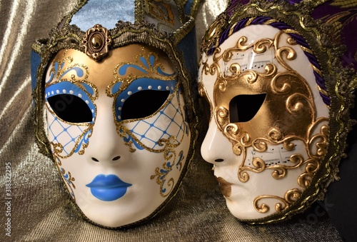 Venetian masks for carnival on a golden background