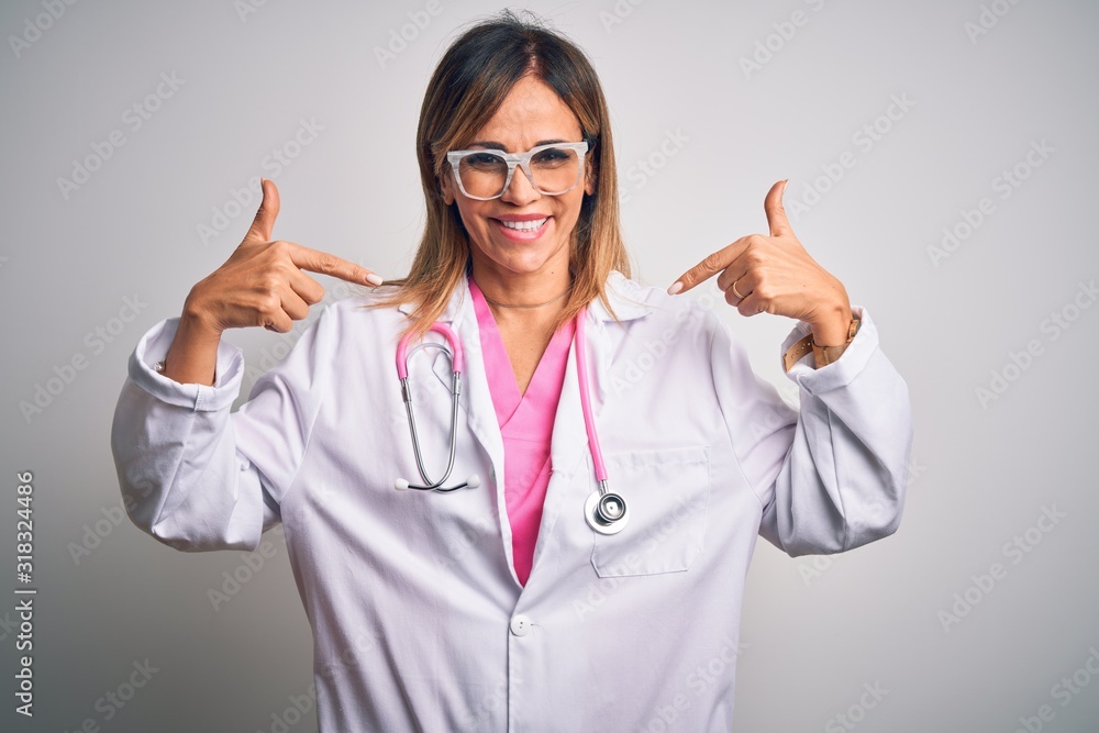 Middle age beautiful doctor woman wearing pink stethoscope over isolated white background looking confident with smile on face, pointing oneself with fingers proud and happy. Middle age beautiful doctor woman wearing pink stethoscope over isolated white background looking confident with smile on face, pointing oneself with fingers proud and happy.