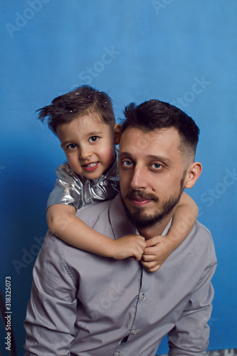 dad in a shirt with his son standing in the Studio