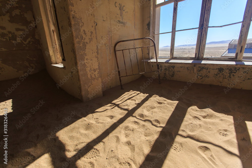Abandoned and forgotten building and room left by people and being taken over by encroaching sandstorm, Kolmanskop ghost town, Namib Desert Abandoned and forgotten building and room left by people and being taken over by encroaching sandstorm, Kolmanskop ghost town, Namib Desert