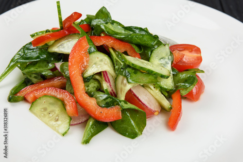 Vegetable vegetarian salad on white plate, closeup