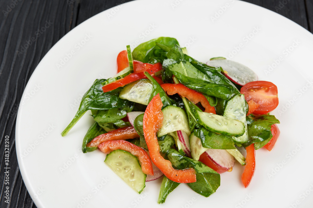 Vegetable vegetarian salad on white plate, closeup Vegetable vegetarian salad on white plate, closeup