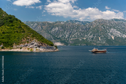 Bay of Kotor, also known as Kotorska Boka, during a quiet summer afternoon with mountains reflecting in the waters of the Adriatic sea. © precinbe