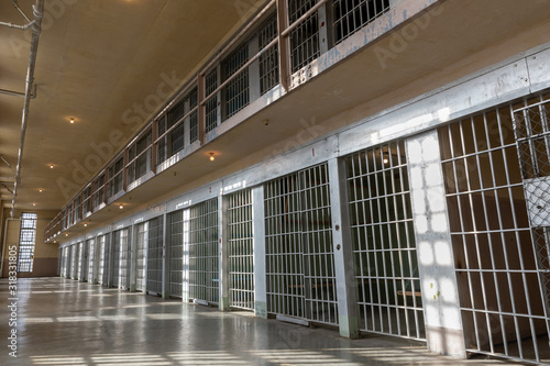 wide angle view of Jail or prison bars being lit up by the sun
