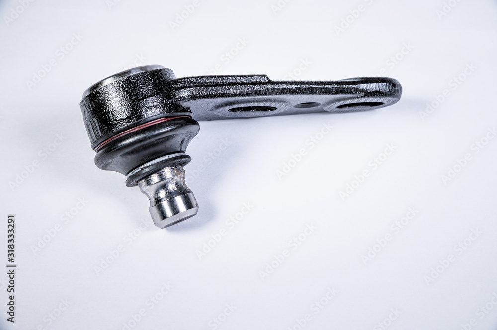 New spare parts spherical ball joints of a suspension bracket of a car on a gray background New spare parts spherical ball joints of a suspension bracket of a car on a gray background
