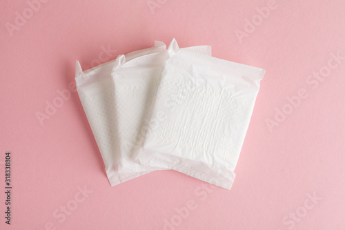 menstruation cycle, feminine hygiene and protection, sanitary pads on pastel pink background, top view, flat layout