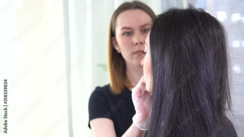 Makeup artist doing make up for beautiful brunette woman Makeup artist doing make up for beautiful brunette woman