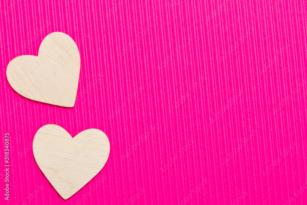 Hearts of wood on the pink corrugated background. Valentine's day background.