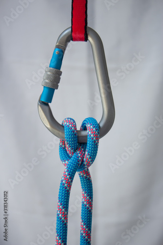 Clove hitch tied with a climbing rope to a pear shaped locking carabiner photo