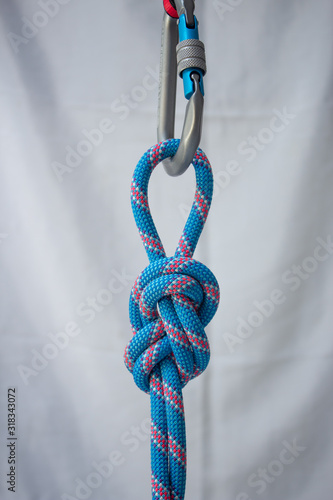 Figure eight on a bight tied with a climbing rope to a pear shaped locking carabiner