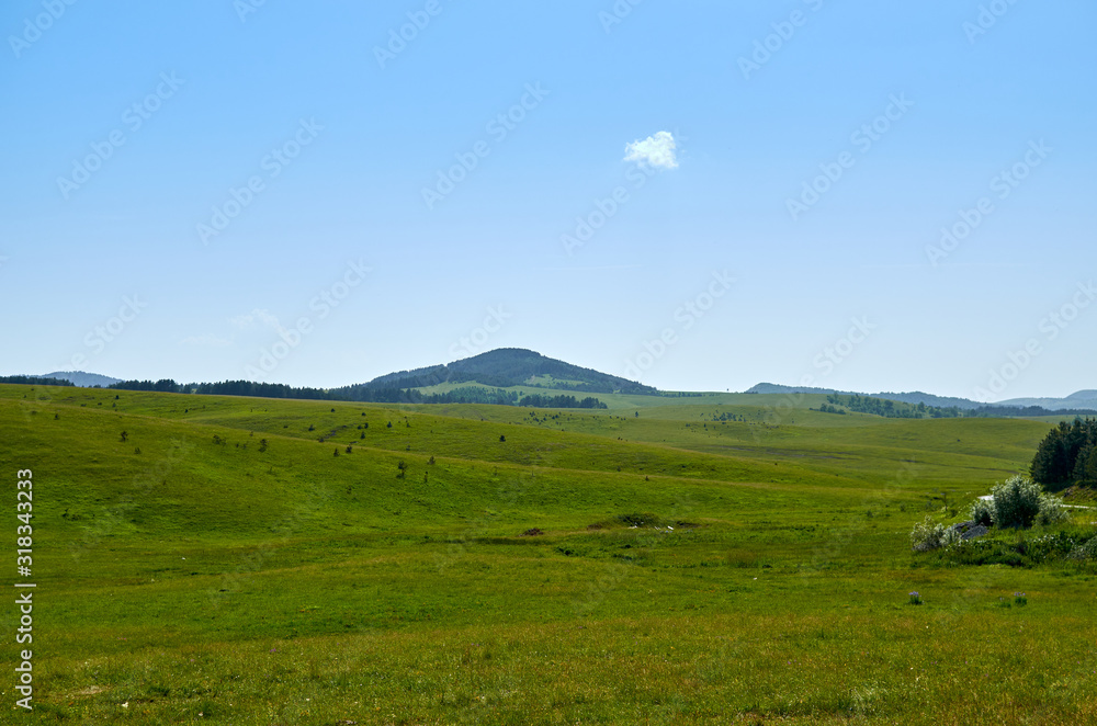 Fototapeta premium Idyllic Serbian mountain landscape - with hills and fields - in spring