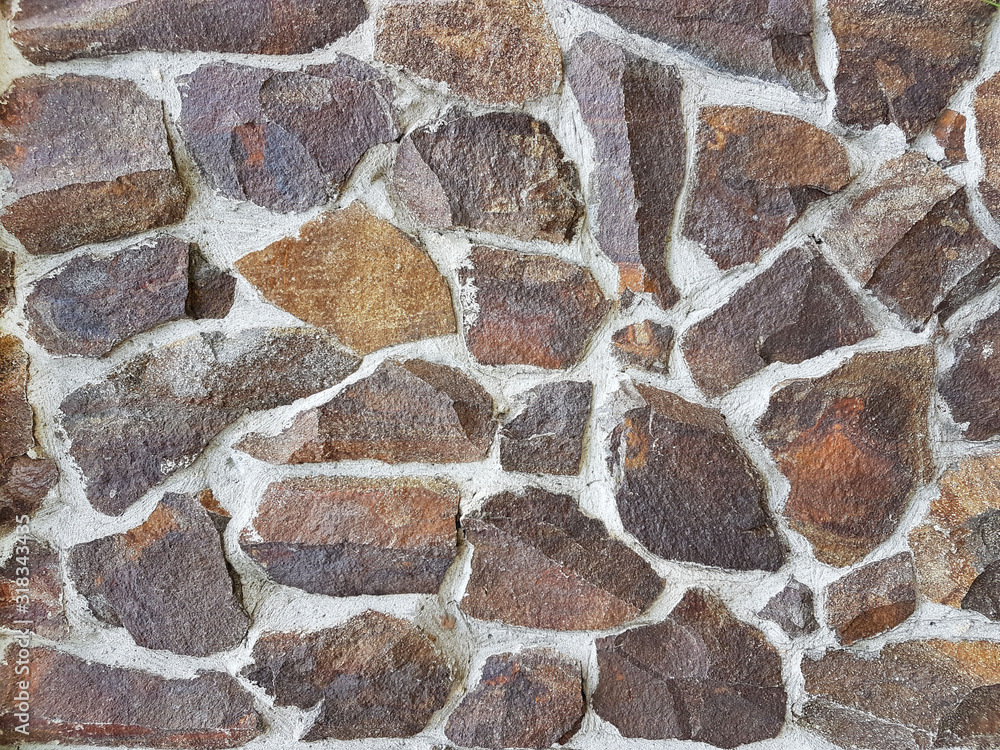 Ancient medieval stone masonry. Texture of a fragment of a wall of an old structure. A background for design and creative work. Decoration and exterior decoration of the building. Construction works Ancient medieval stone masonry. Texture of a fragment of a wall of an old structure. A background for design and creative work. Decoration and exterior decoration of the building. Construction works
