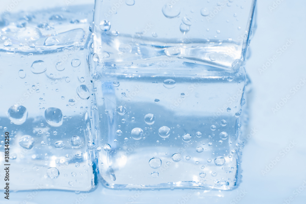 Ice cubes macro square with drops water clean on blue background Ice cubes macro square with drops water clean on blue background