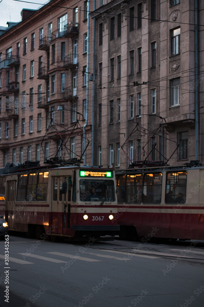 red tram rides along the street