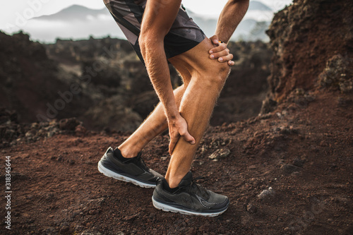 Schilderij op canvas Male runner holding injured calf muscle and suffering with pain