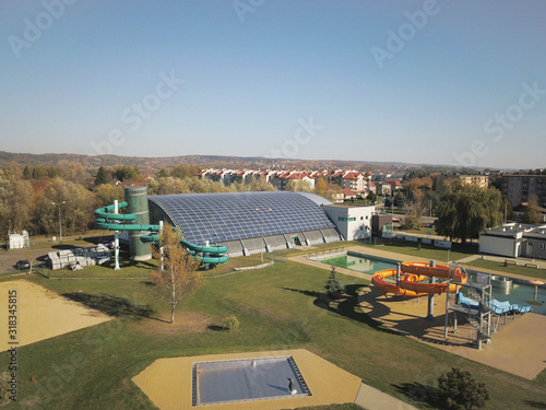 Jaslo, Poland - Oct. 15 2018: MOSiR Municipal Sports Complex with an indoor swimming pool with a waterslide and sports fields. Modern and healthy lifestyle. View from height of flight of the unmanned photo