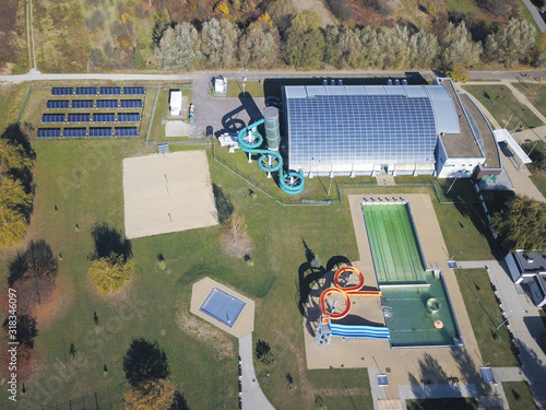 Jaslo, Poland - Oct. 15 2018: MOSiR Municipal Sports Complex with an indoor swimming pool with a waterslide and sports fields. Modern and healthy lifestyle. View from height of flight of the unmanned photo