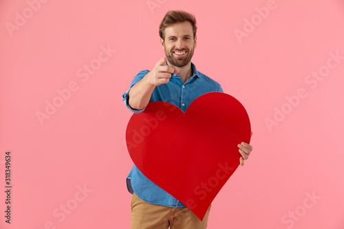 happy casual guy smiling and holding big red heart © Viorel Sima
