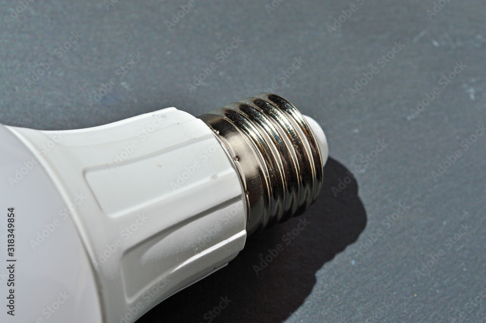 base of the LED lamp E27 lamp. on a dark background. base of the LED lamp E27 lamp. on a dark background.