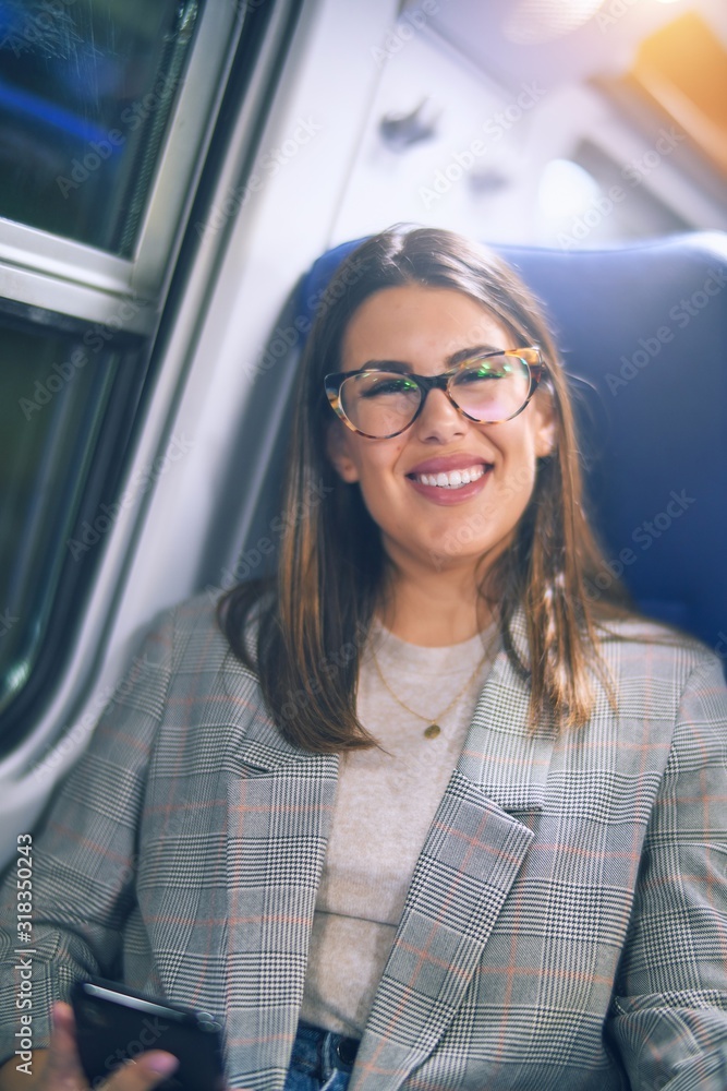 Young beautiful woman smiling happy and confident. Sitting with smile on face travelling by train