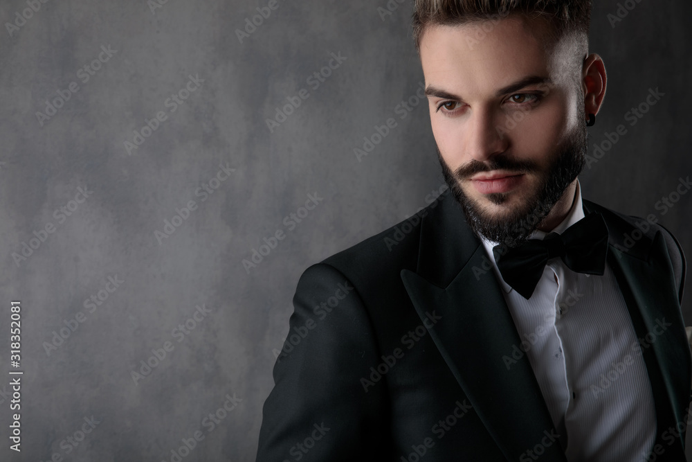 sexy businessman wearing black tuxedo and looking away pensive sexy businessman wearing black tuxedo and looking away pensive