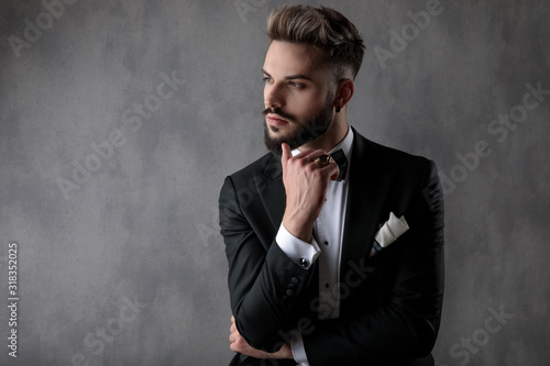 businessman sitting with hands folded and looking aside pensive