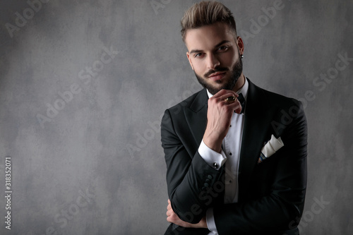 businessman sitting with hands folded and looking at camera happy