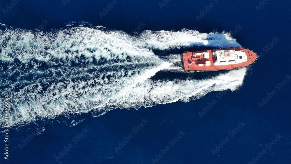 Naklejka premium Aerial drone photo of pilot tug vessel cruising in Mediterranean container logistics port