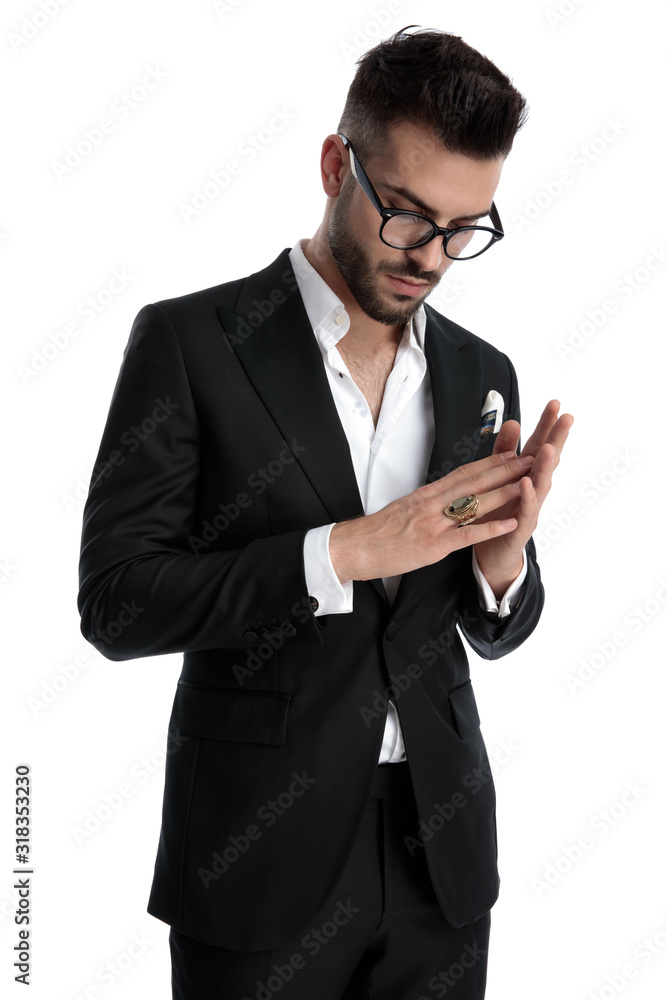 businessman standing and rubbing hands while looking down businessman standing and rubbing hands while looking down