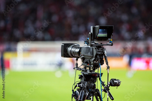 TV camera at the stadium, broadcasting during a football (soccer) match