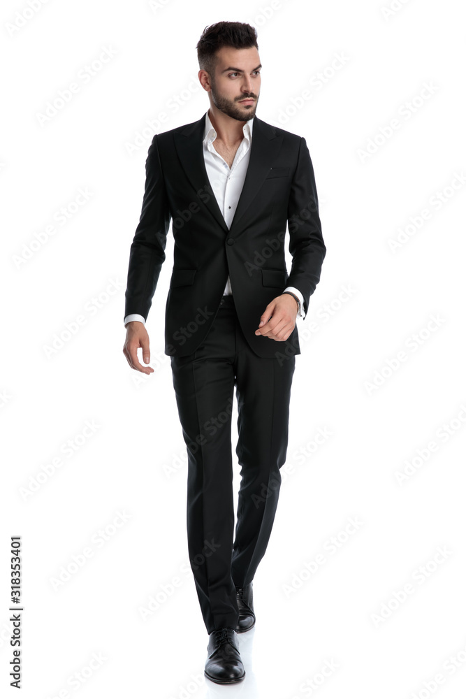 businessman walking with loose hands and looking away pensive businessman walking with loose hands and looking away pensive