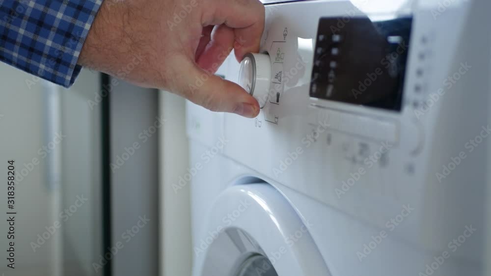 Man Close the Laundry Machine Front Door Set the Program and Push Start Button Man Close the Laundry Machine Front Door Set the Program and Push Start Button