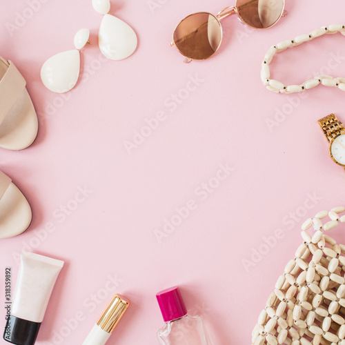 Frame border made of summer fashion composition with female accessories on pink background. Bag, perfume, sunglasses, shoes, earrings, lipstick, watch. Flat lay, top view blank copy space mockup.