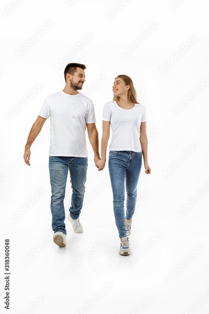 full length portrait of happy couple in casual outfit walking forward together on white background full length portrait of happy couple in casual outfit walking forward together on white background