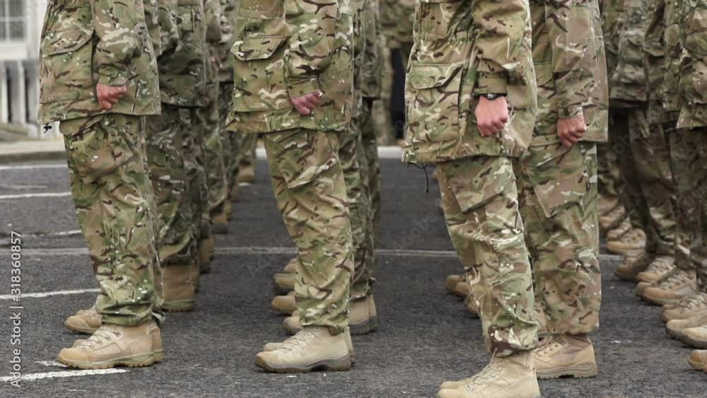 Army Soldiers turn in unison during a Homecoming parade. They perform an about turn in camouflage uniform. Super Slow Motion Army Soldiers turn in unison during a Homecoming parade. They perform an about turn in camouflage uniform. Super Slow Motion