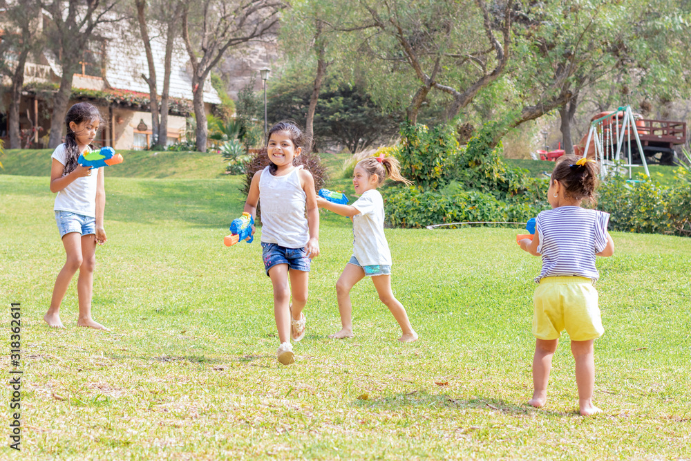 Obraz premium Little girls playing with water in the summer