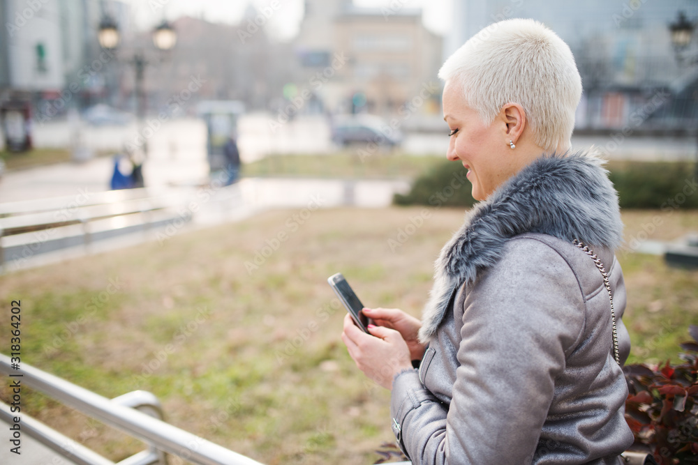 Woman on the street uses a cellphone Woman on the street uses a cellphone